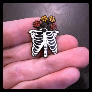 Skeleton rib cage with flowers blooming from insid
